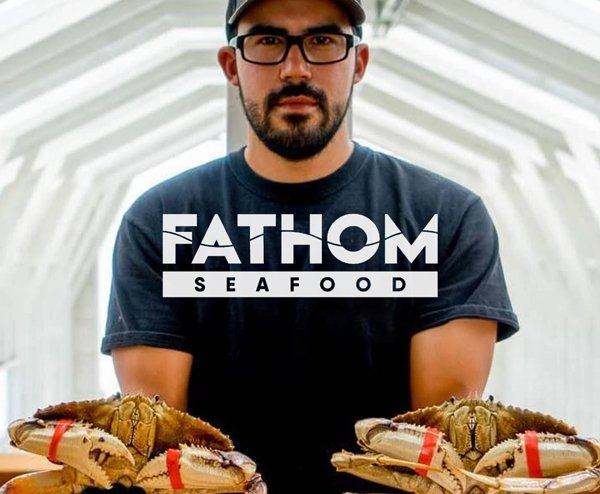 Operations manager holding crabs.