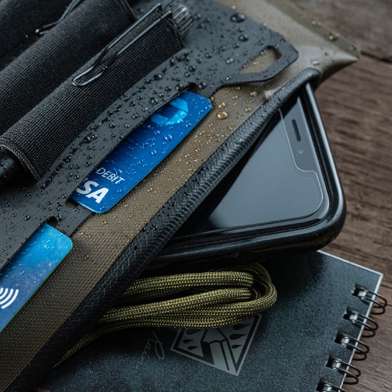 Pocket organizer filled with gear and notebook.