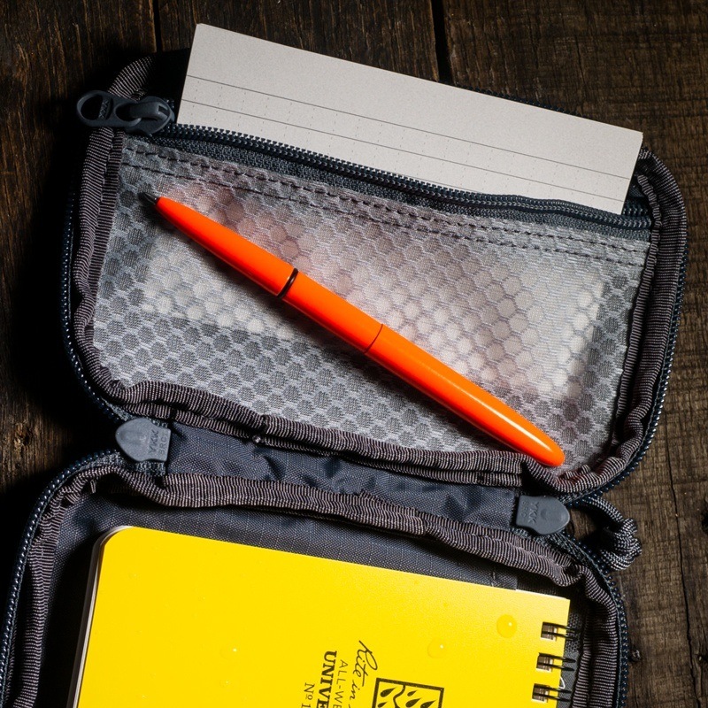 Pocket organizer holding  index cards, pen, and notebook.