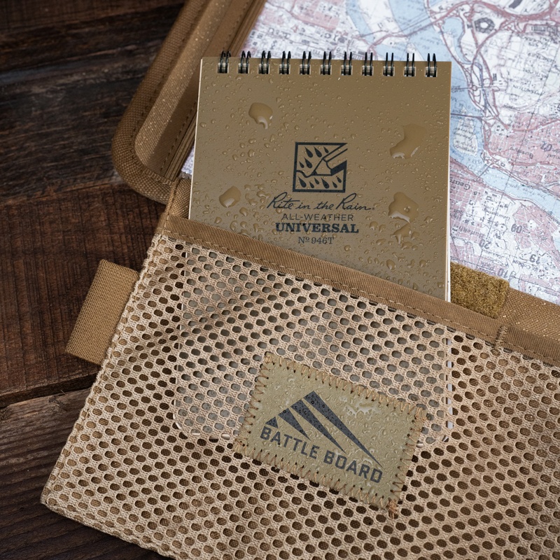Kneeboard showing meshpocket with notebook inside.