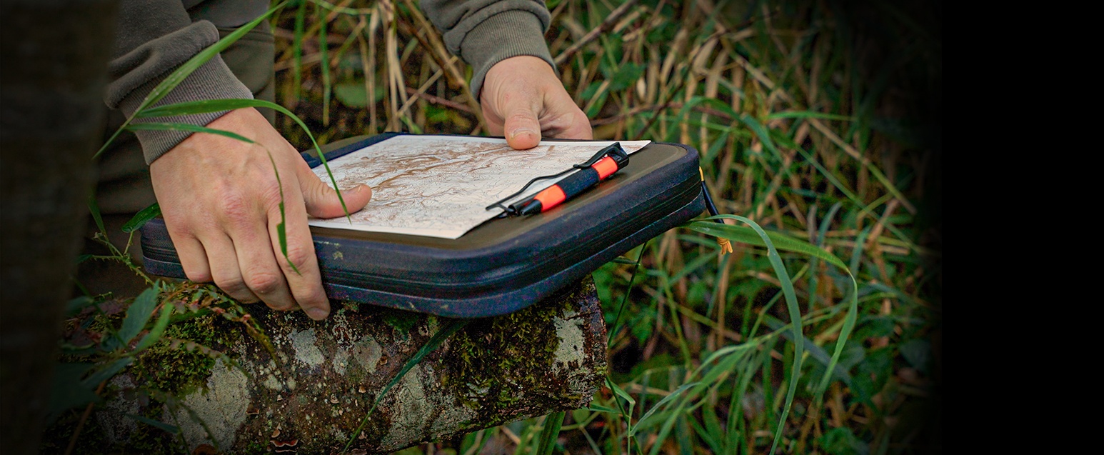 Weatherproof clam desk being held on a rock.